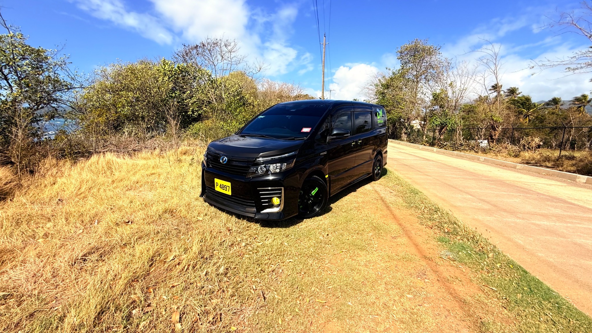 Black Drivah van parked on a scenic Grenada road