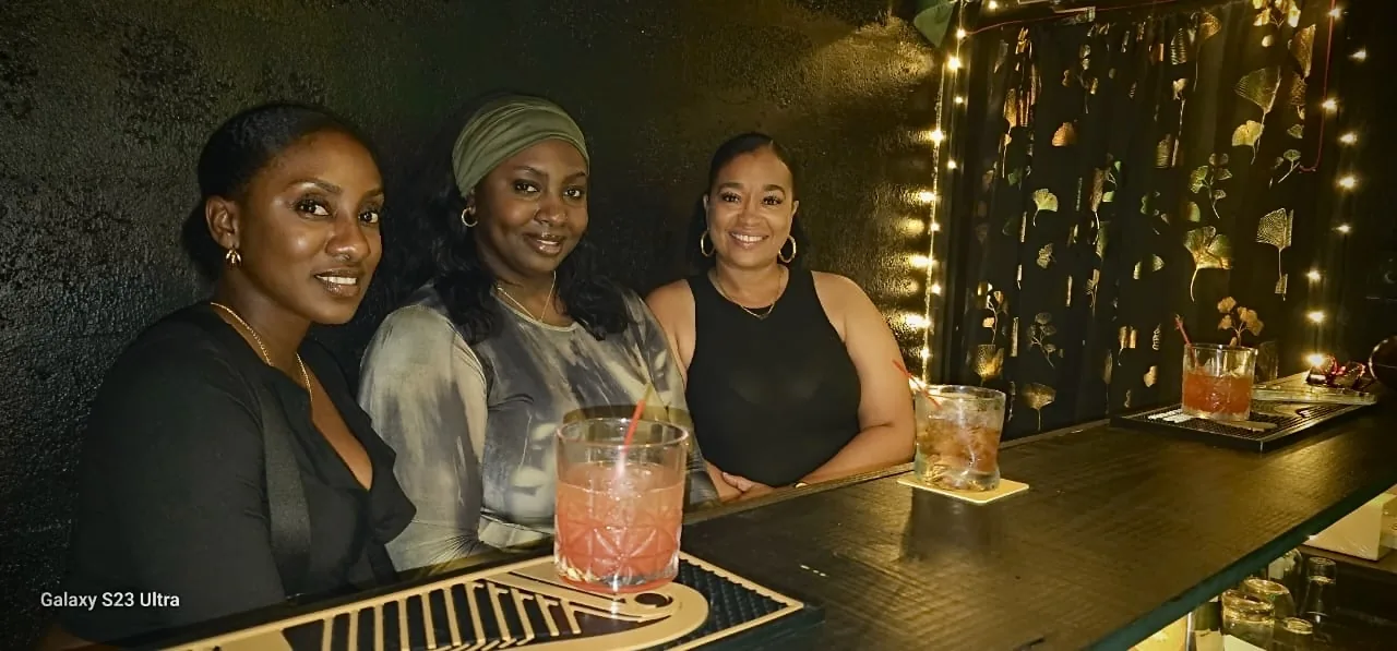 Three guests enjoying drinks together at the JustDior bar